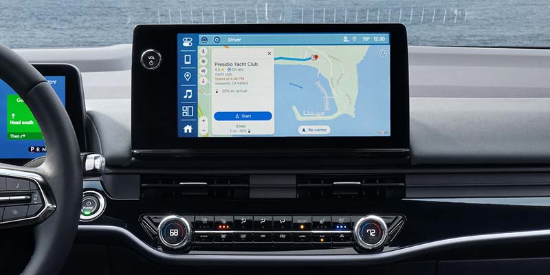 Center screen of a car showing a navigation route to Presidio Yacht Club